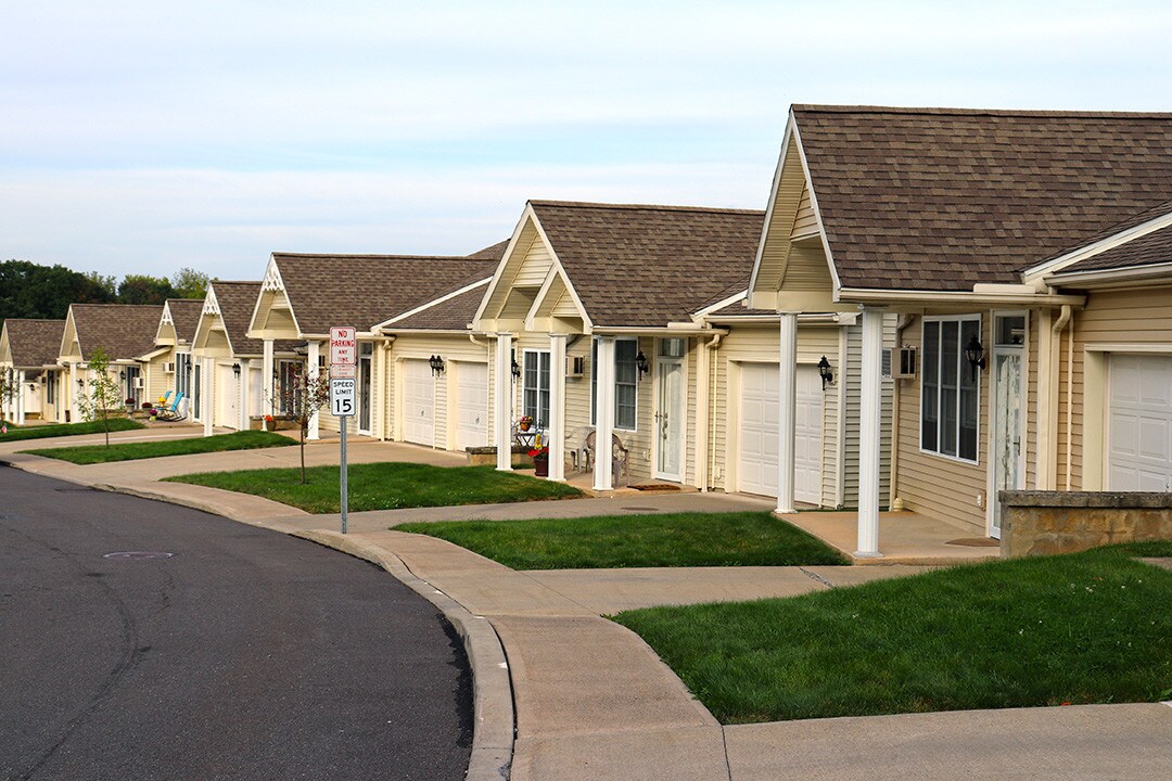 Row of Lexington Village garden-style homes with attached garages along a curved street