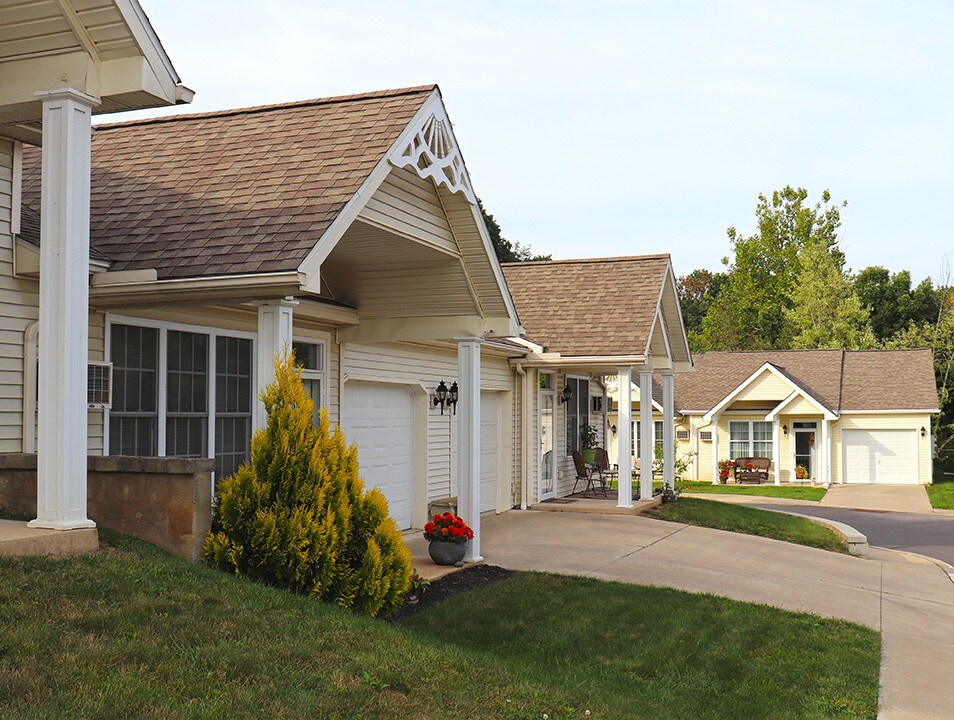 Lexington Village homes with gabled porches and garages beside the driveway