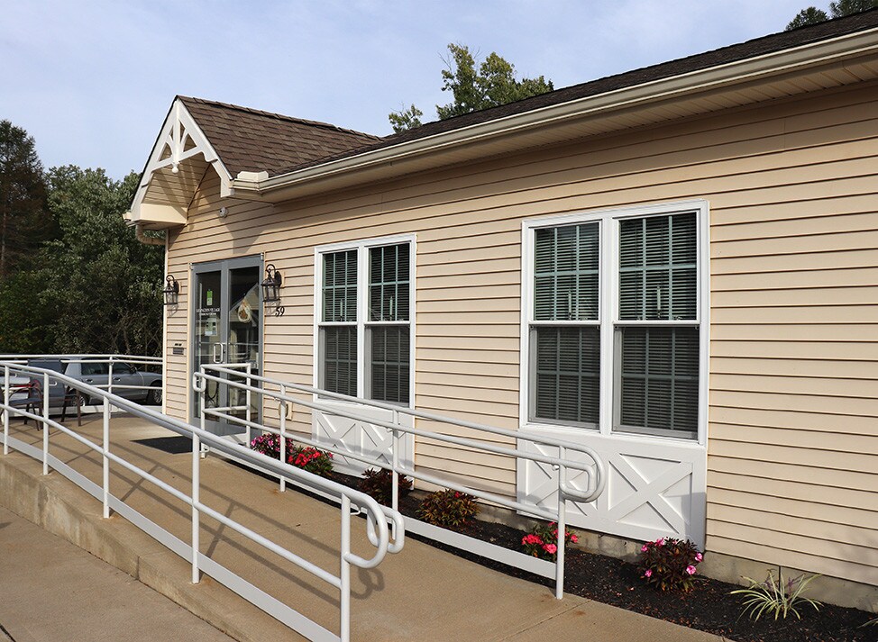 Lexington Village leasing office entrance with accessible ramp and flower beds